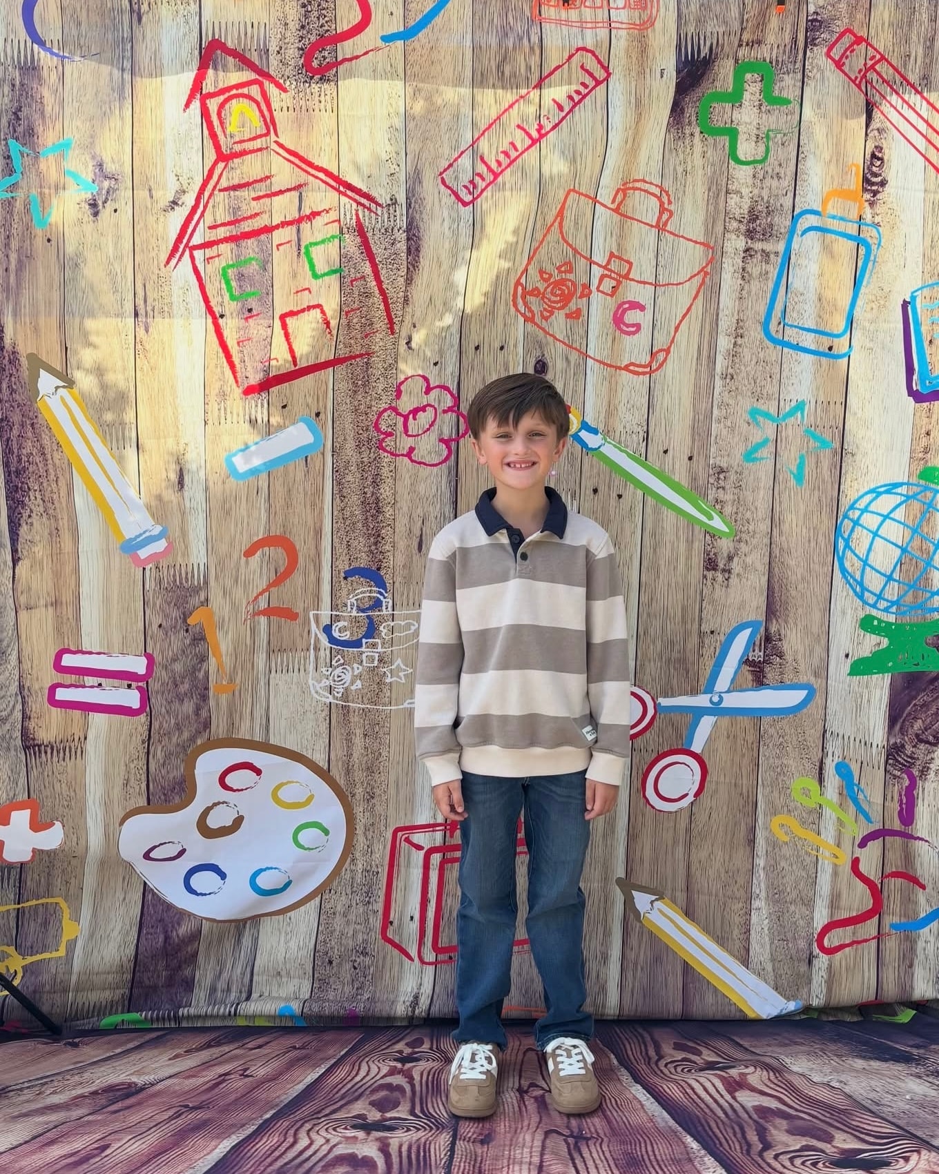 Boy in gray striped sweater and jeans at the Back 2 School Stroll