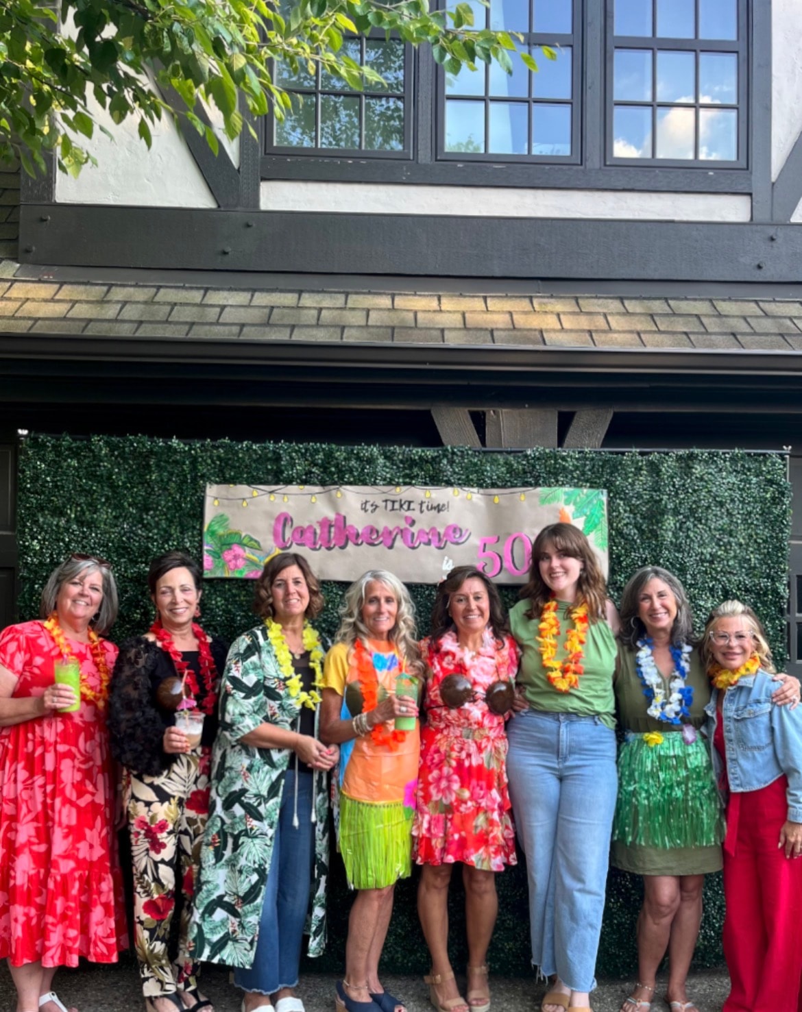 Twice Blessed team celebrating Catherine's 50th birthday tiki party — group photo with leis and tropical outfits
