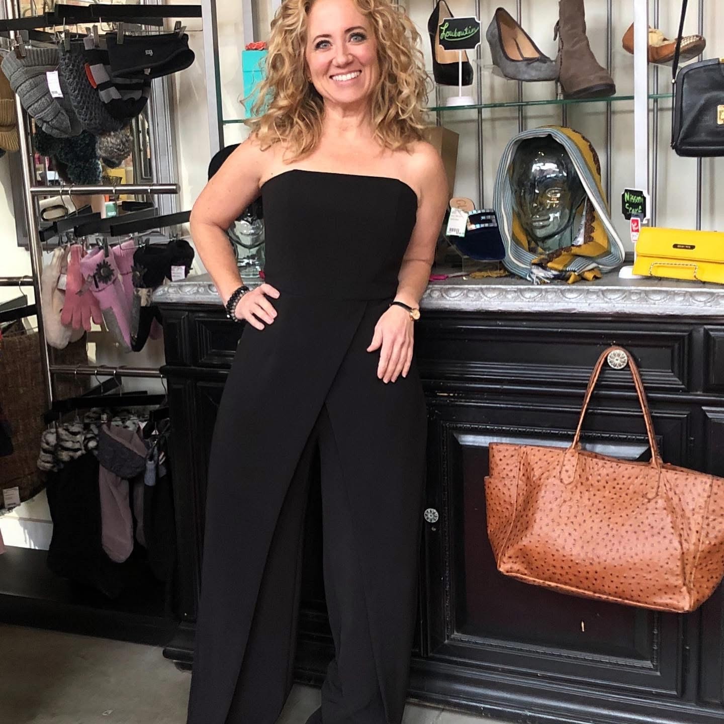 Woman in black strapless jumpsuit at Twice Blessed boutique