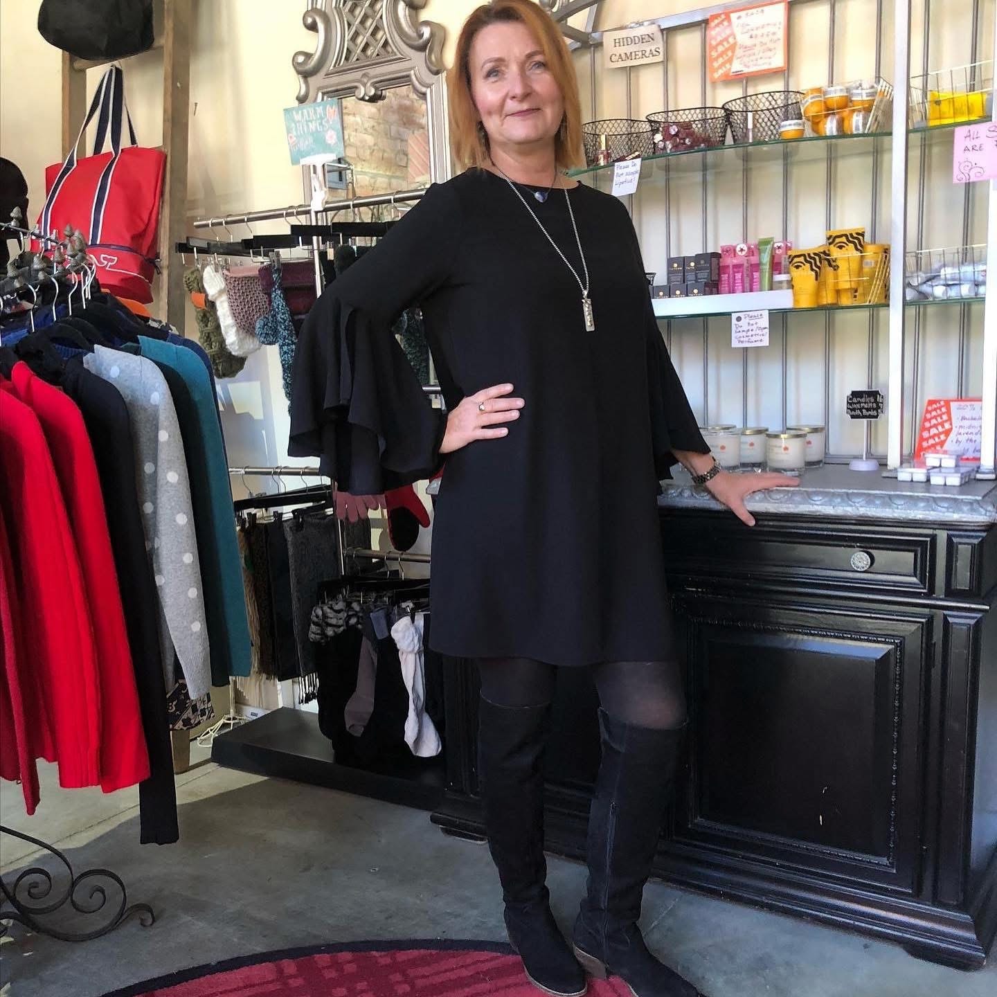 Woman in black ruffle-sleeve dress at Twice Blessed boutique