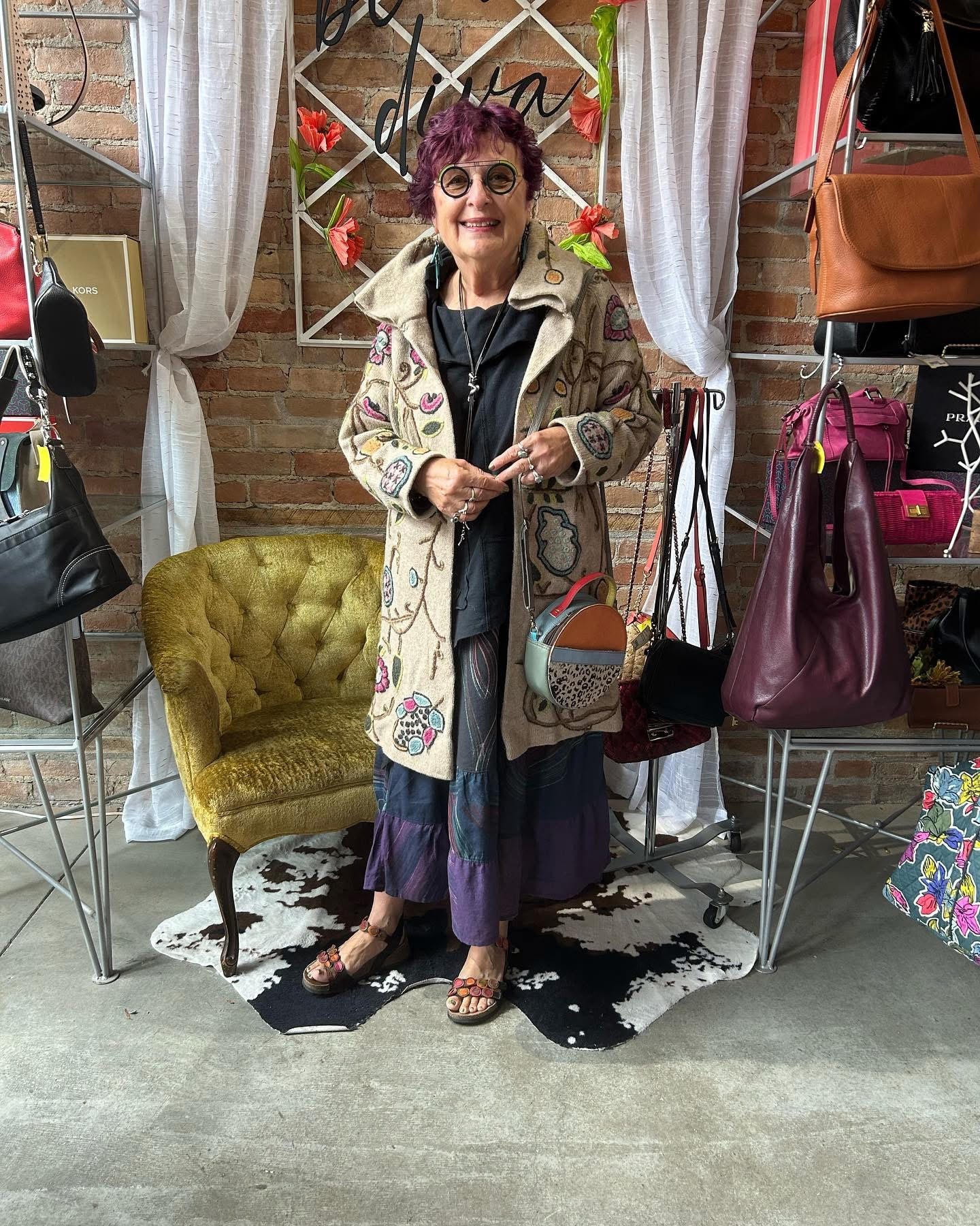 Woman in colorful boho embroidered coat at Twice Blessed boutique