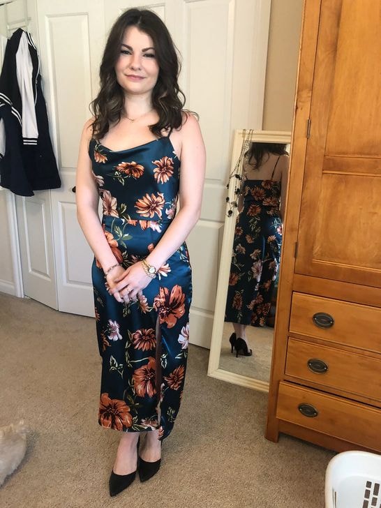 Customer modeling floral satin dress at Twice Blessed boutique