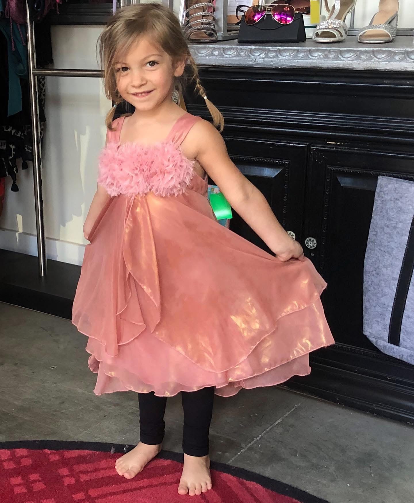 Girl modeling pink tiered dress at Twice Blessed boutique