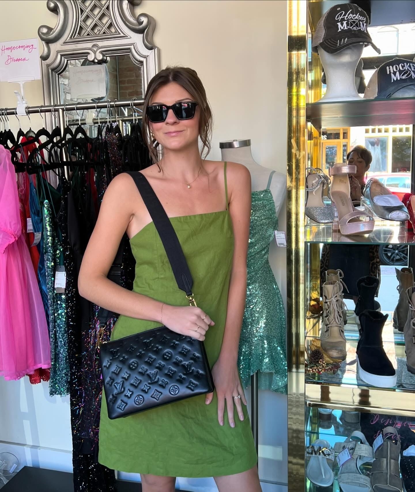 Young woman in olive green dress with Louis Vuitton crossbody bag at Twice Blessed boutique