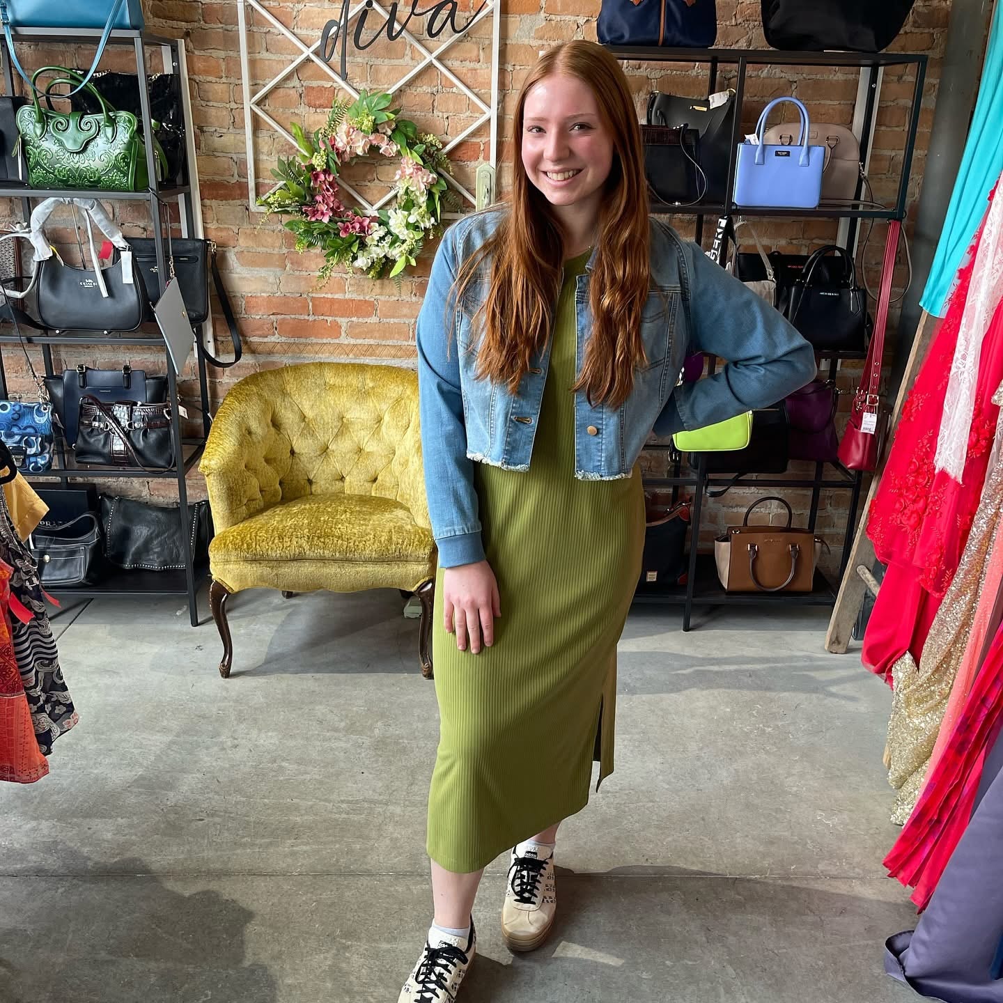Young woman in olive ribbed maxi dress with cropped denim jacket at Twice Blessed boutique