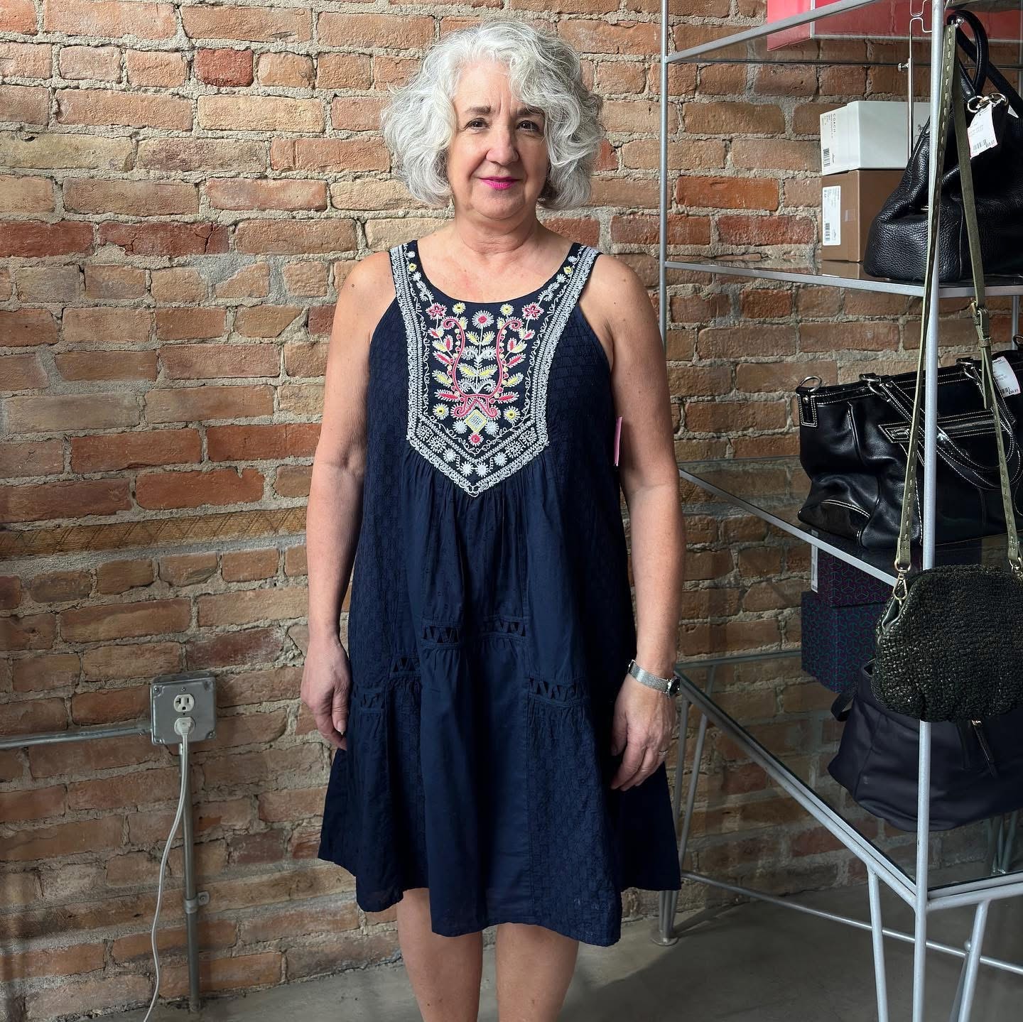Woman in navy embroidered sleeveless dress at Twice Blessed boutique