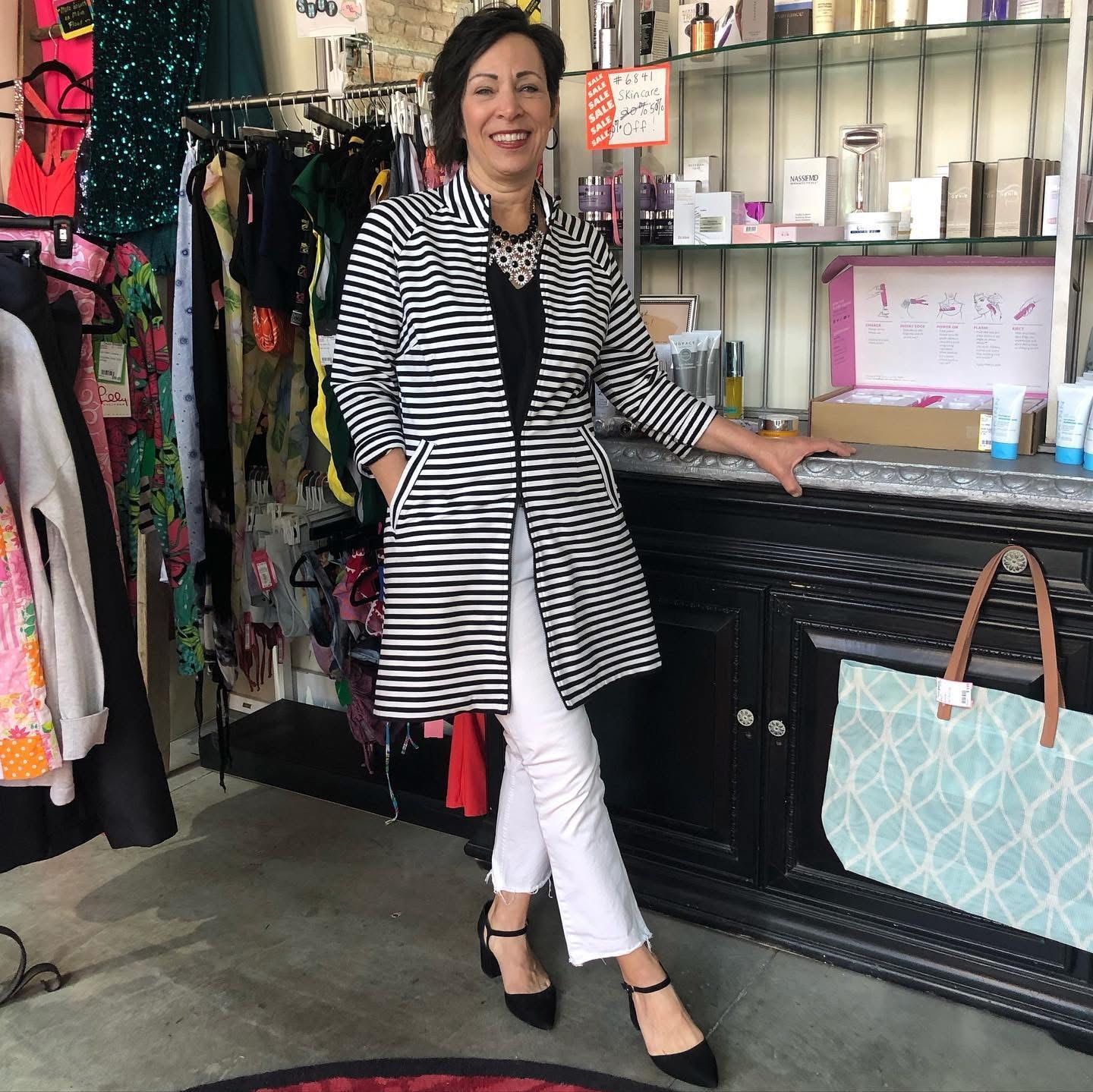 Woman smiling in boutique clothing store