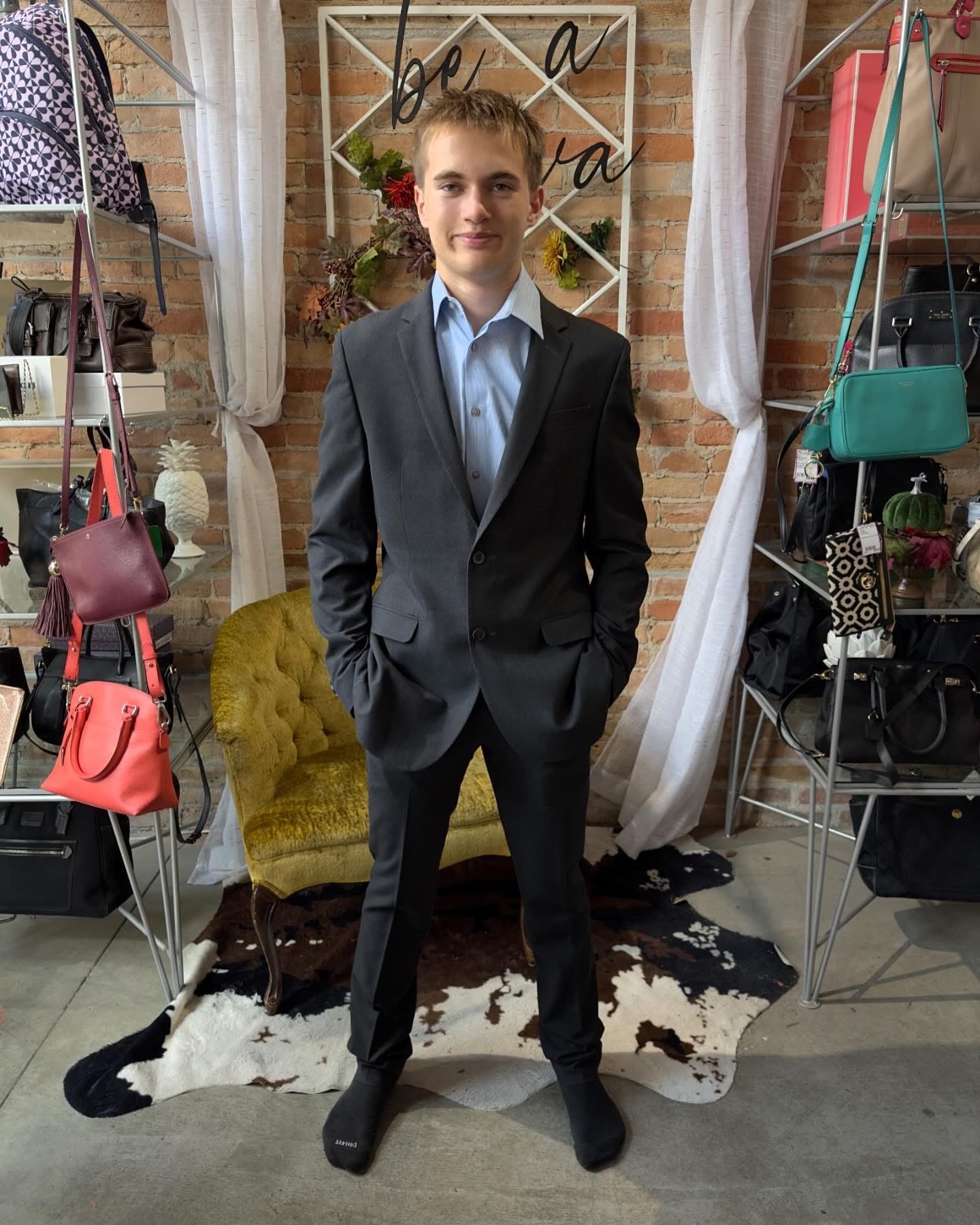 Teen boy in charcoal suit and light blue shirt at Twice Blessed boutique