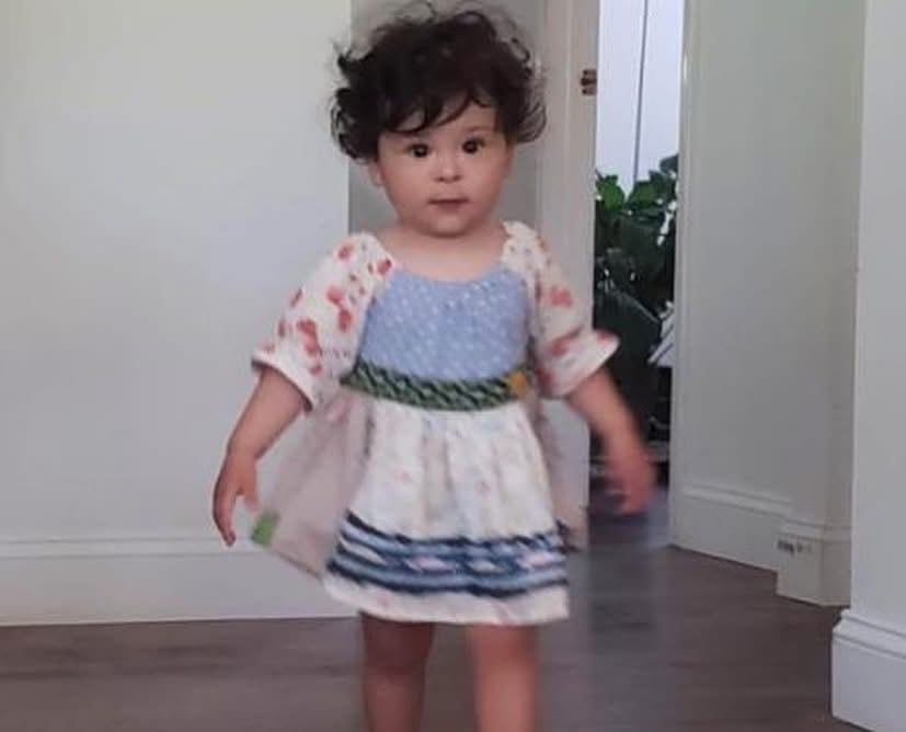 Adorable toddler girl modeling a floral dress from Twice Blessed boutique