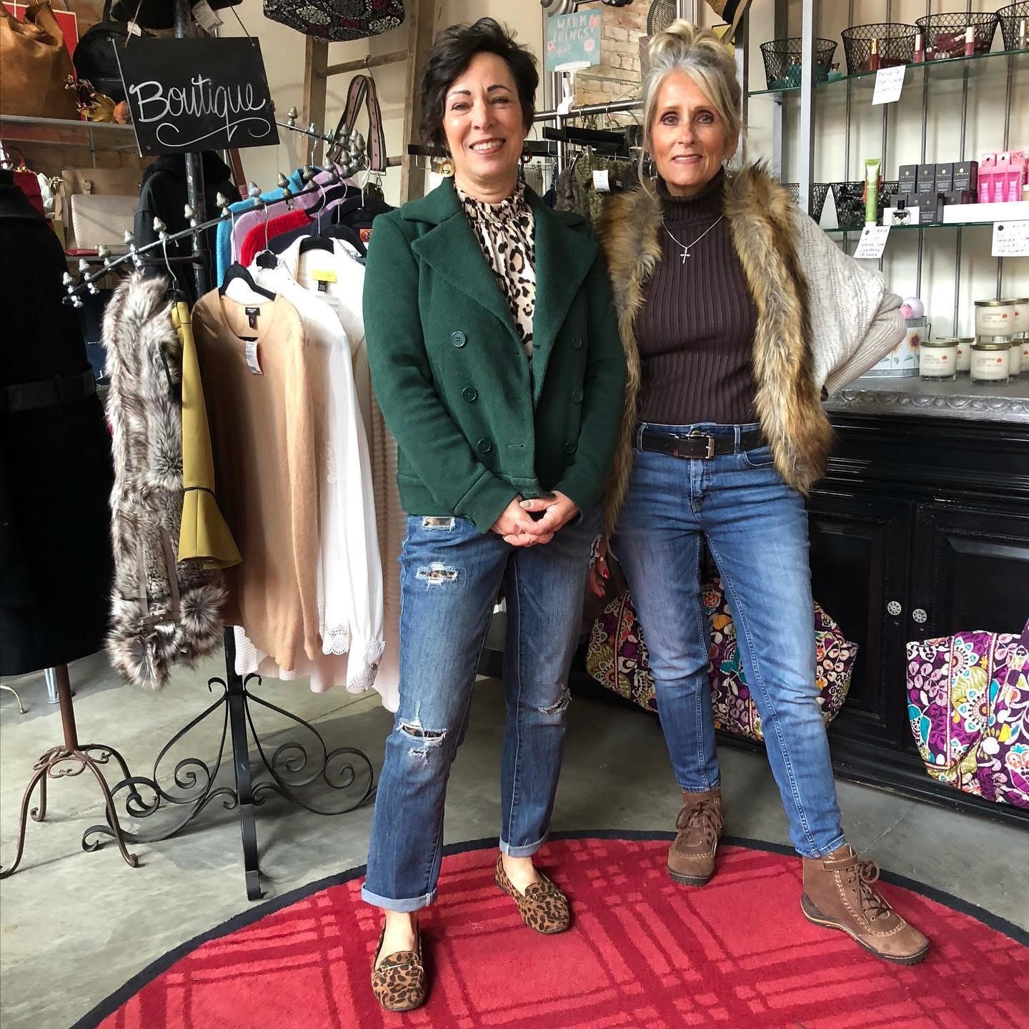 Two women in green blazer and fur vest posing at Twice Blessed boutique