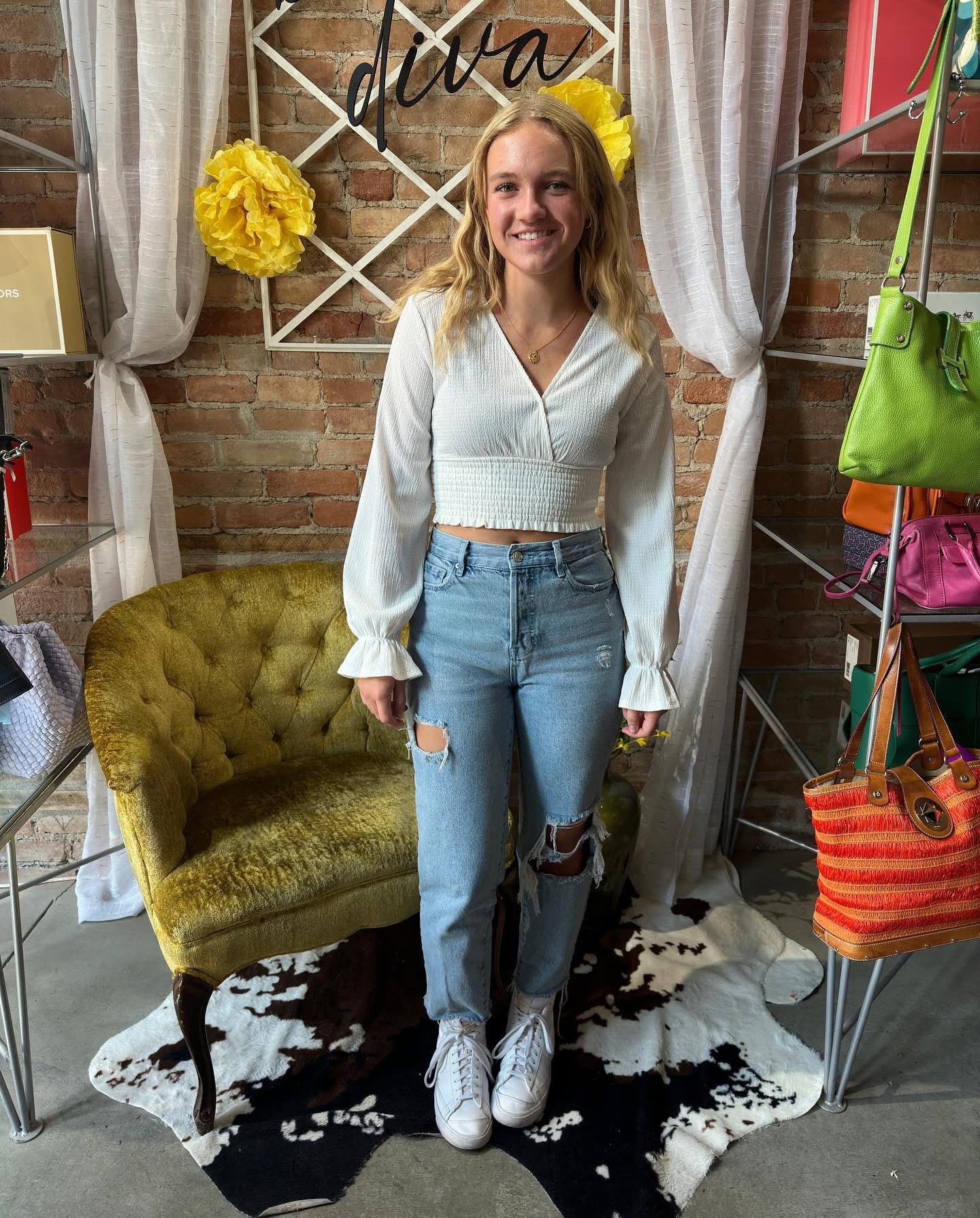 Young woman in white crop top and ripped jeans at Twice Blessed boutique