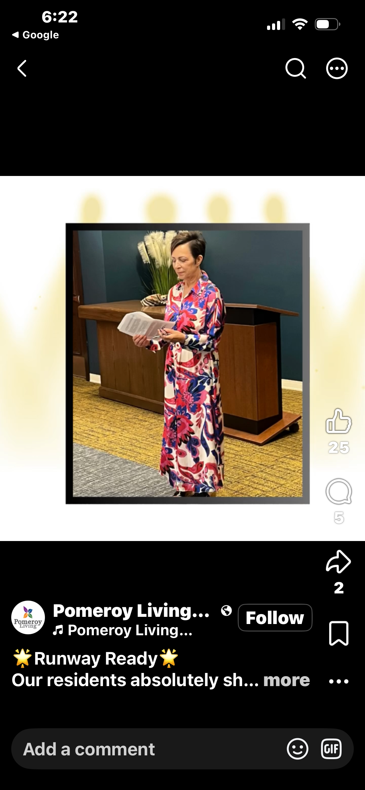 Fashion show host in a bold floral maxi dress at the Pomeroy Living Senior Fashion Show