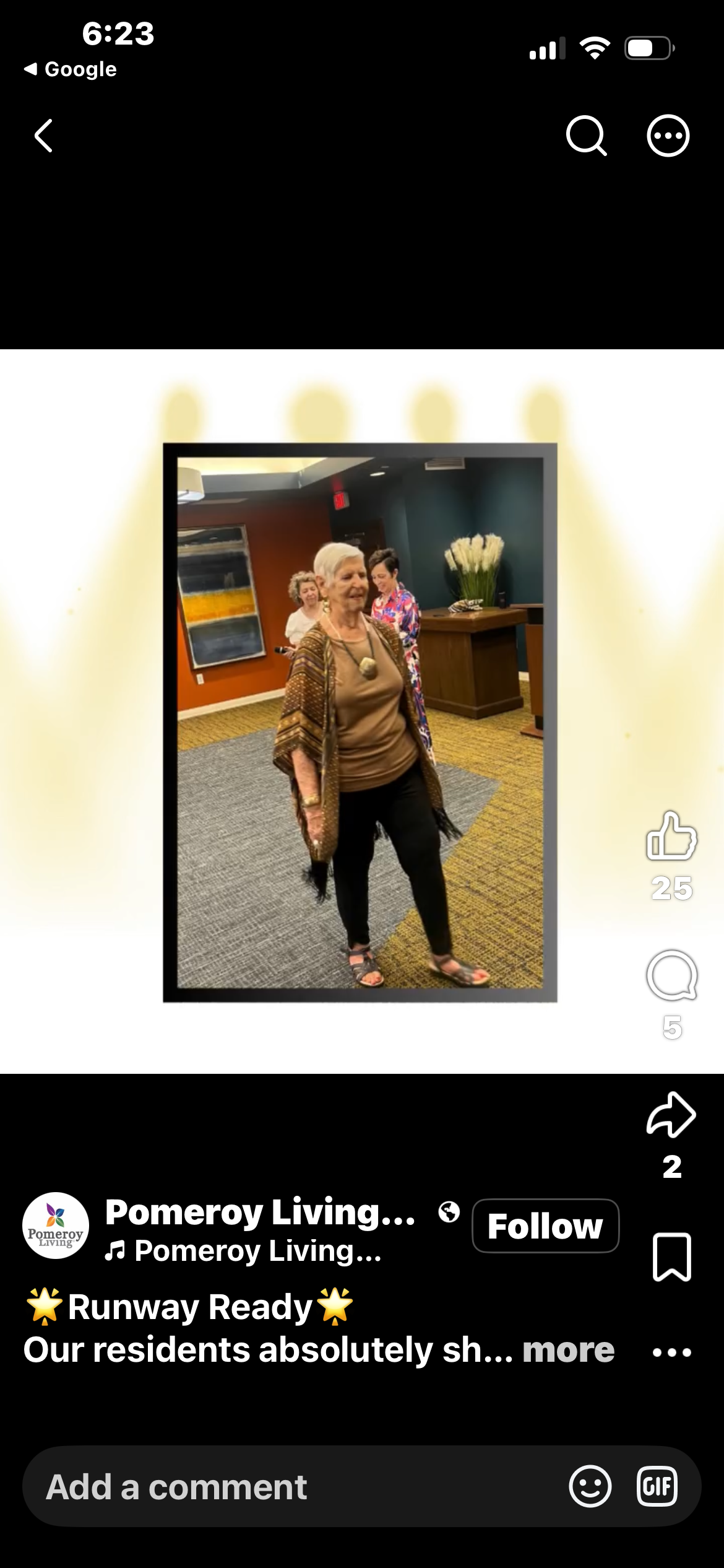 Pomeroy Living resident modeling a brown fringe poncho on the runway at the Senior Fashion Show