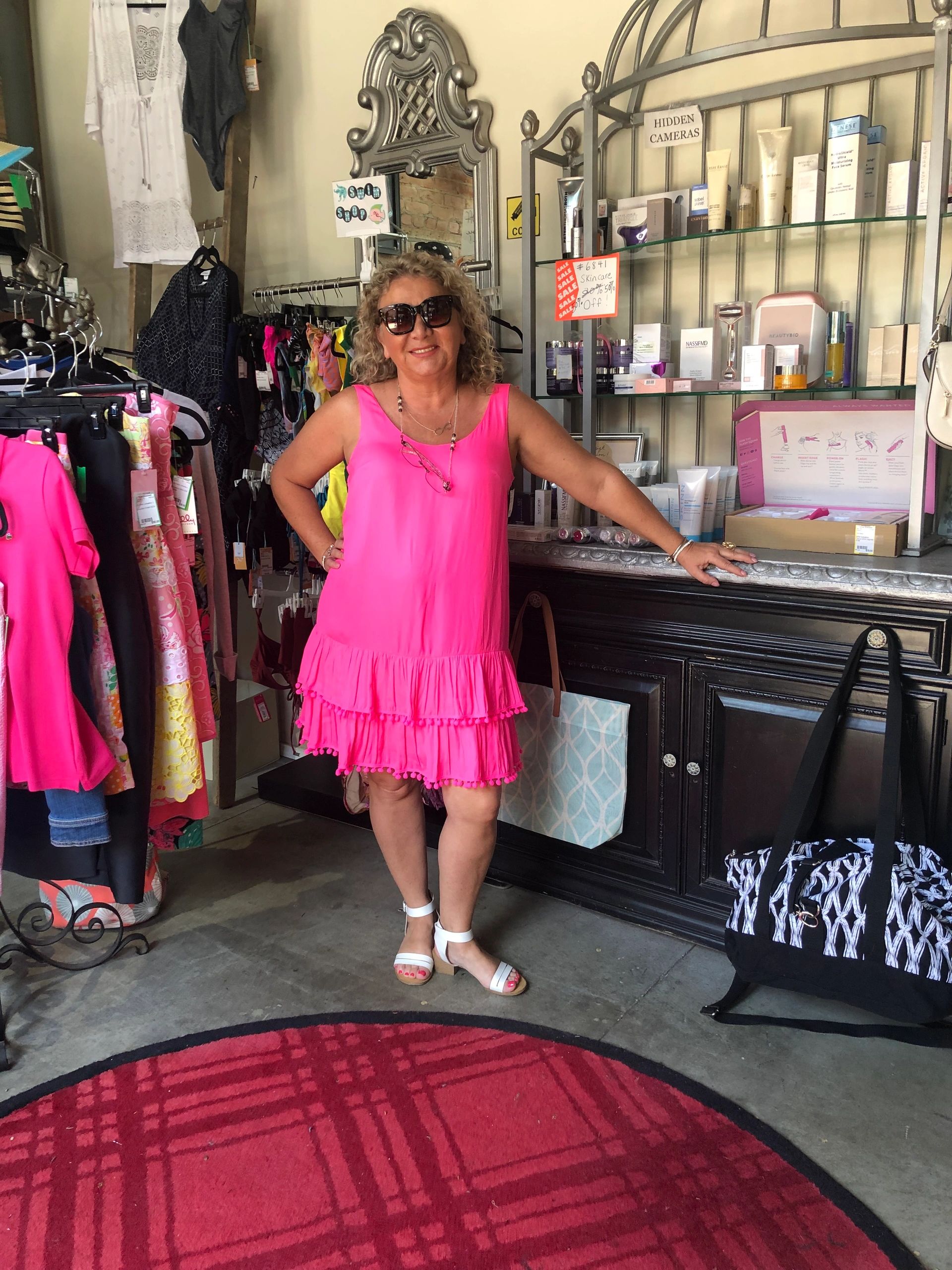 Woman in pink ruffled dress at boutique