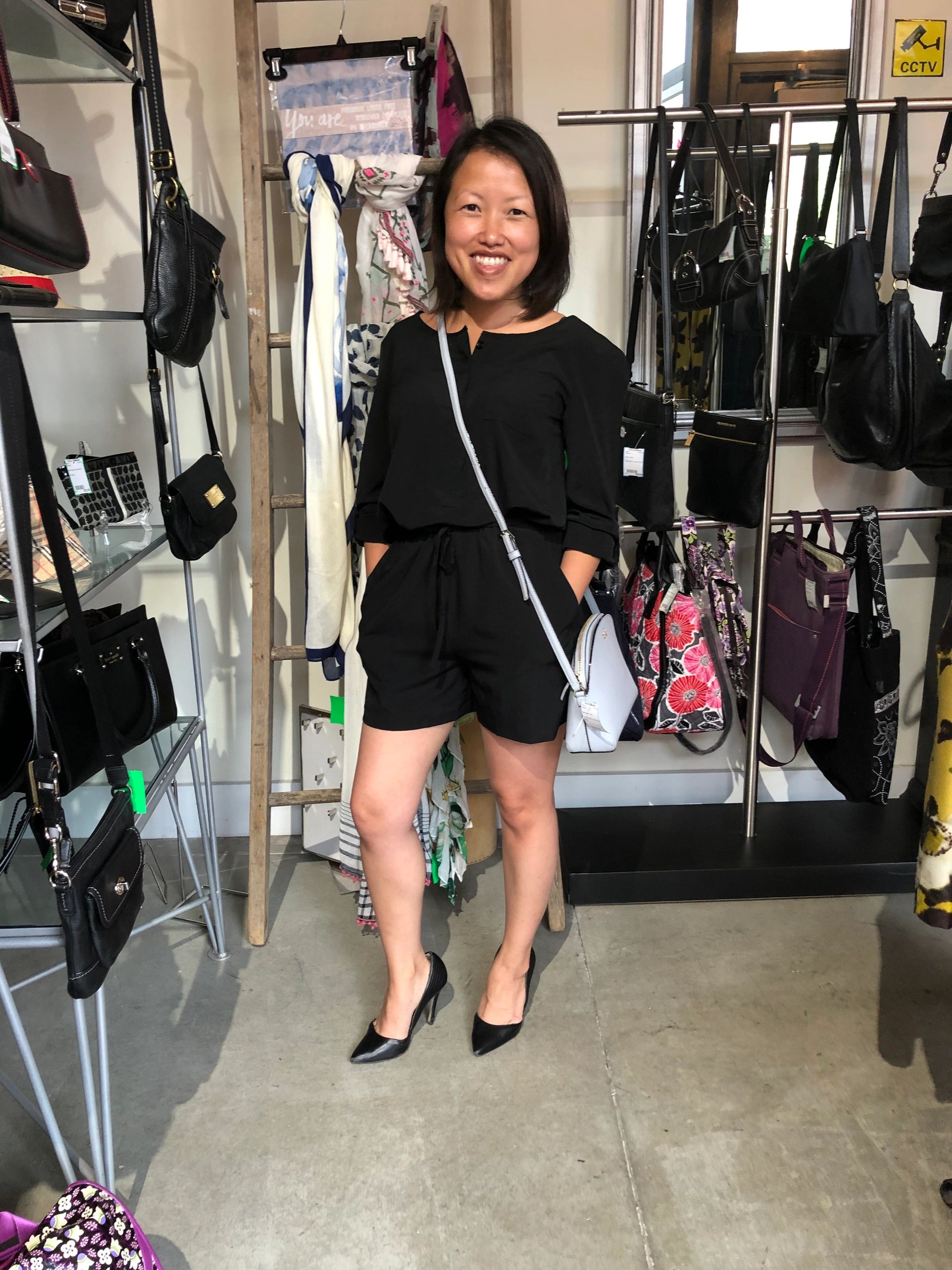 Woman in black romper at clothing store