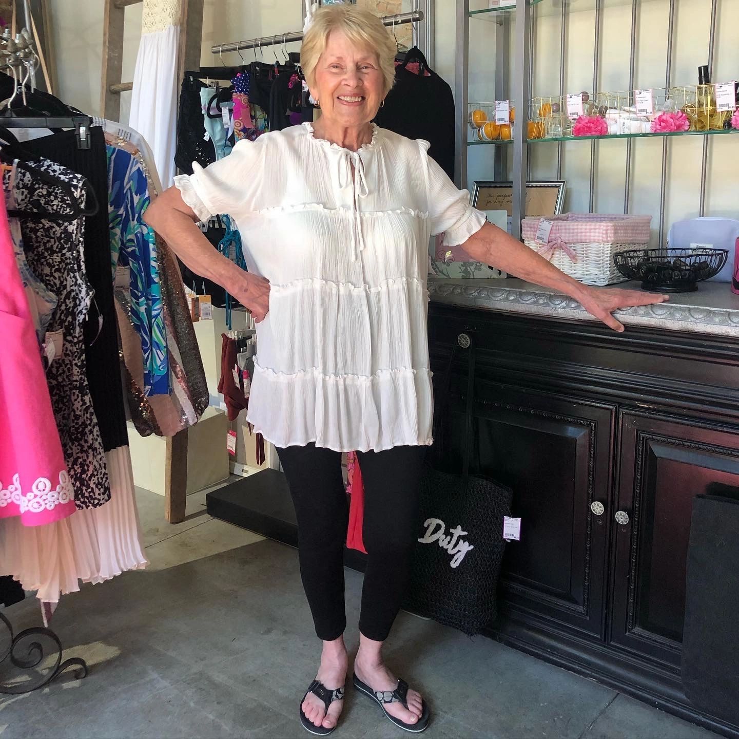 Woman in white top at boutique counter