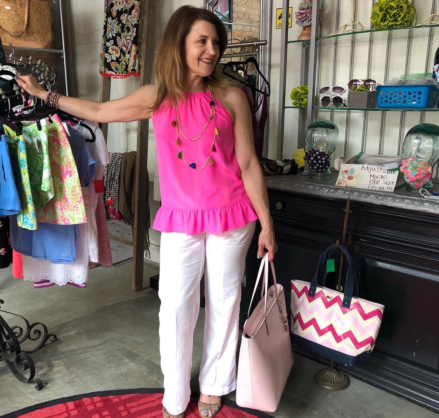 Woman in pink halter top with patterned bag