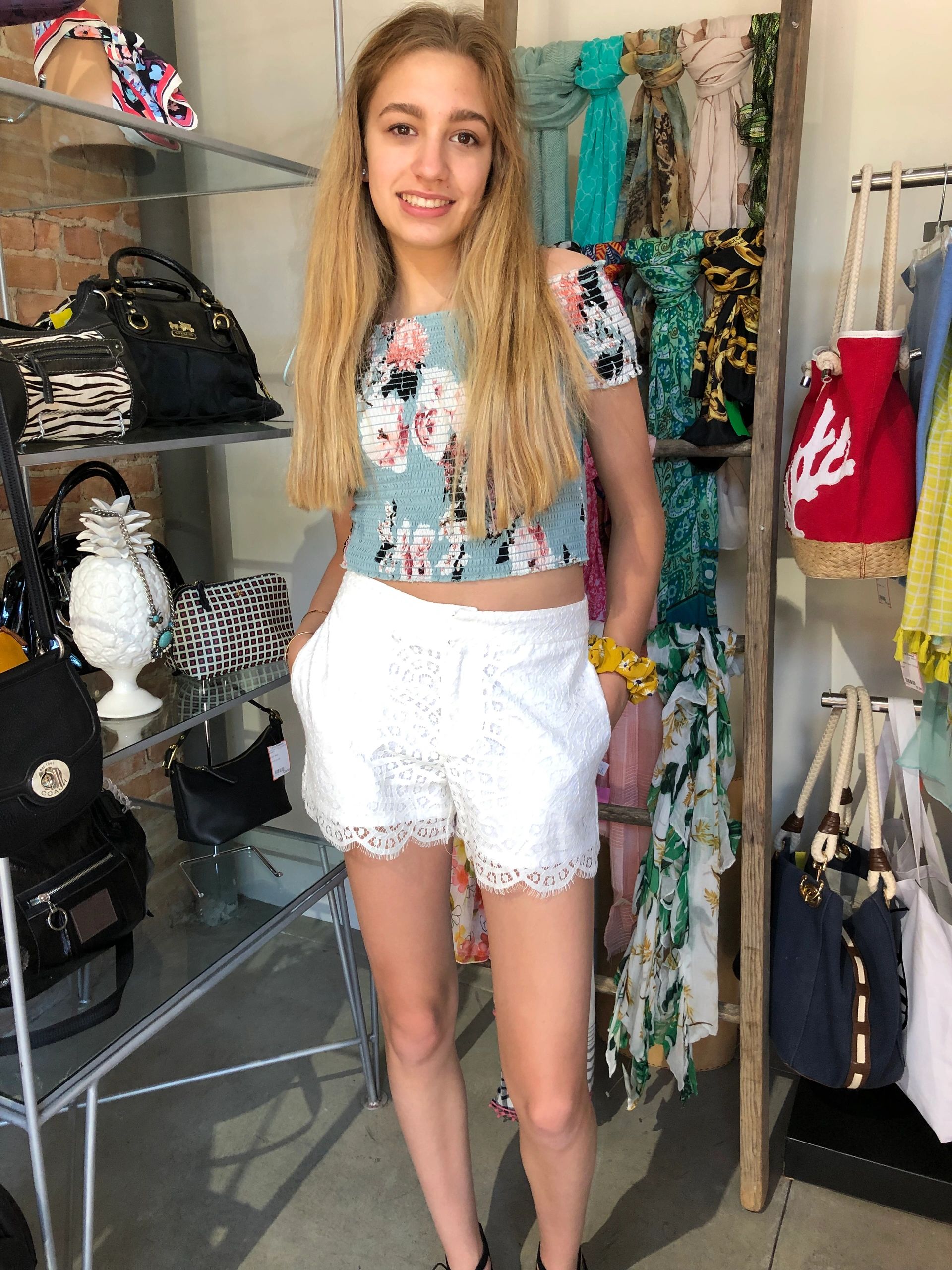 Young woman in floral crop top at boutique