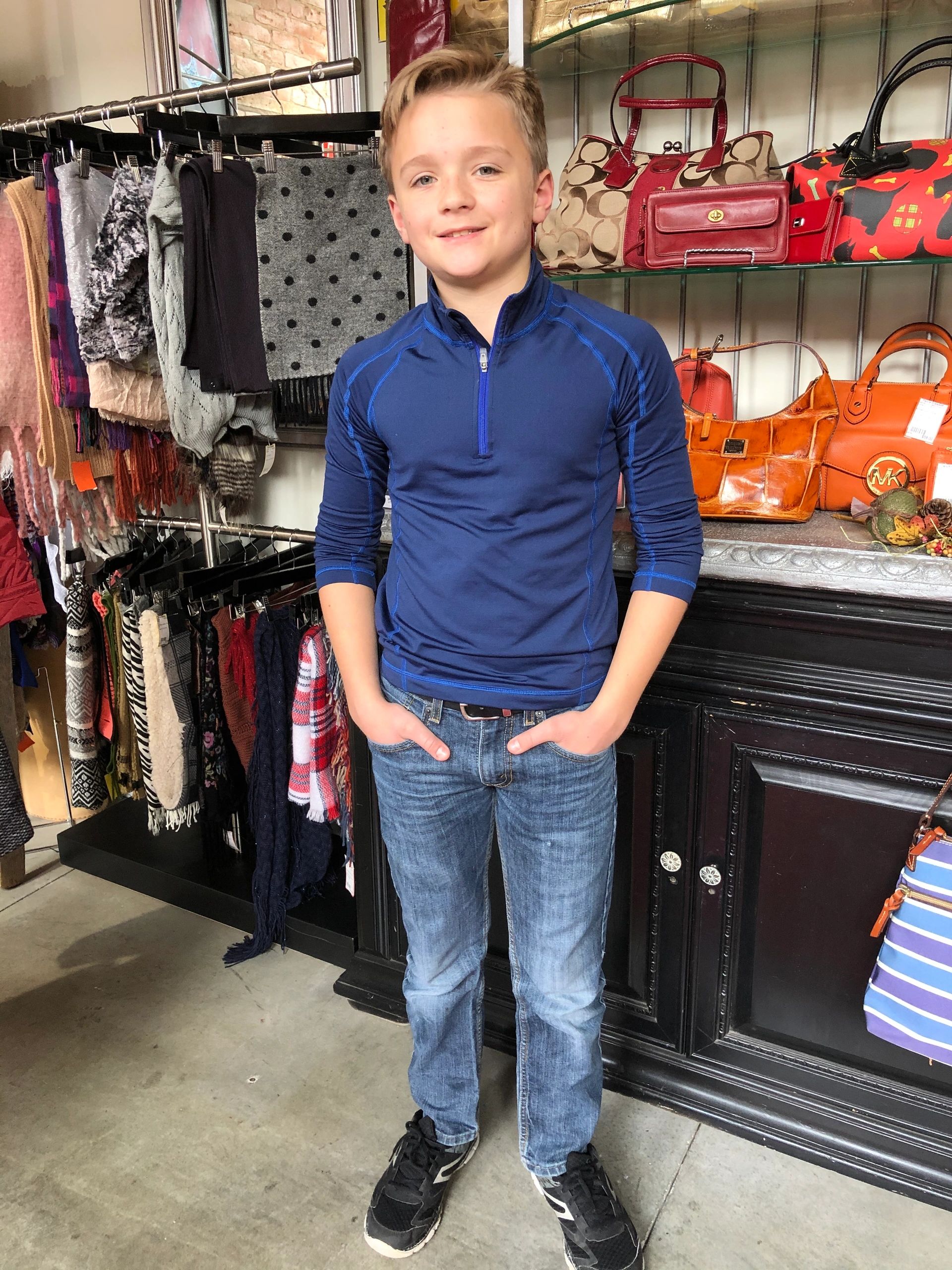 Boy in blue pullover at clothing store